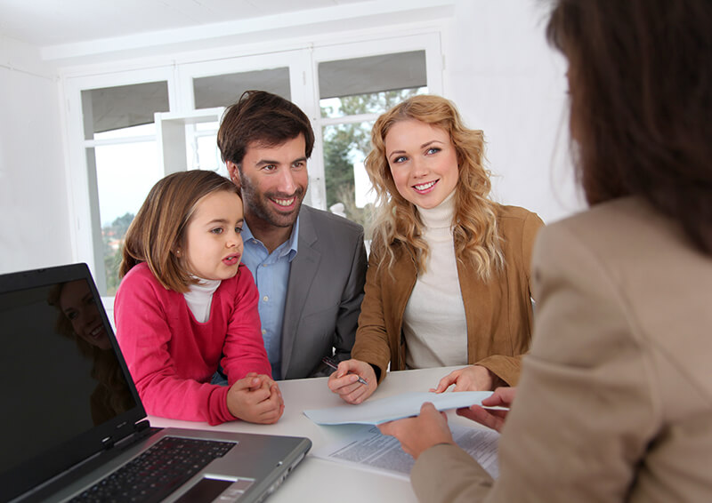 Happy family signing loan forms